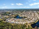 Wide aerial view showcasing the community and waterfront at 664 Linden Dr, Englewood, FL 34223