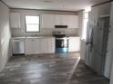 Modern kitchen with stainless steel appliances and white cabinets at 8426 Sweden Blvd, Punta Gorda, FL 33982