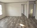 Bright and spacious living room with wood-look flooring at 8426 Sweden Blvd, Punta Gorda, FL 33982