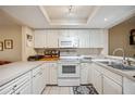 White kitchen with appliances and ample counter space at 958 Sunridge Dr # H3, Sarasota, FL 34234