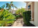 Brick walkway leading to a charming front door at 107 Corte Del Rosa, Venice, FL 34285