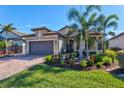 Single-story home with attached garage and well-manicured landscaping at 13064 Rinella St, Venice, FL 34293