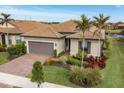 One-story house with a tile roof and palm trees in the front yard at 13836 Karina St, Venice, FL 34293