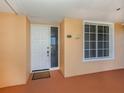 Condo entry with white door and window with shutters at 157 Tampa E Ave # 407, Venice, FL 34285