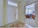 Bright entryway with white door and view into home office at 1655 Lancashire Dr # 1655, Venice, FL 34293