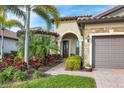 Welcoming entryway with palm trees and a brick walkway at 18987 Formosa St, Venice, FL 34293