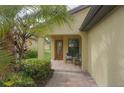 Inviting entryway with a covered patio and brick walkway at 19155 Mangieri St, Venice, FL 34293