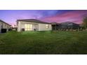 Spacious backyard with screened patio and lush lawn at 1932 W Isles Rd, Port Charlotte, FL 33953
