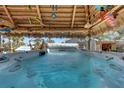 Relax in this large hot tub under a shaded tiki hut at 1985 Fairview Dr, Englewood, FL 34223