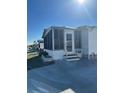 Side view of a white single-wide manufactured home with screened porch at 199 Palm Air Dr, Osprey, FL 34229