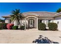 Front view of house showcasing entryway and landscaping at 20 Saint Croix Way, Englewood, FL 34223