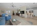 Open living room with fireplace, comfortable seating, and adjacent kitchen at 205 Tortuga Dr, Nokomis, FL 34275