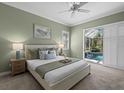 Spacious bedroom with pool view, light walls, and calming decor at 205 Tortuga Dr, Nokomis, FL 34275