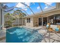 Inviting screened pool area with lounge chairs and a water feature at 205 Tortuga Dr, Nokomis, FL 34275