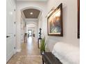 Bright and spacious entryway with tile flooring, seating, and artwork at 23402 Copperleaf Dr, Venice, FL 34293