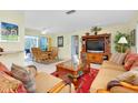 Bright living room features comfortable seating, a large TV, and a view into the dining area at 237 San Marco Dr, Venice, FL 34285
