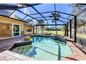 Relaxing screened pool and spa overlooking a lush golf course at 269 Royal Oak Way, Venice, FL 34292