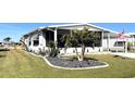 Landscaped yard with a palm tree and decorative rock at 28 Castaway Ct, North Port, FL 34287