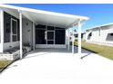 Covered carport with screened enclosure and paved area at 28 Castaway Ct, North Port, FL 34287