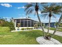 Landscaped yard with palm trees and a mobile home at 3022 Audubon Ave, Englewood, FL 34224