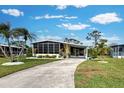 Mobile home with a landscaped yard and driveway at 3022 Audubon Ave, Englewood, FL 34224