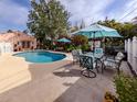 Relaxing poolside patio area with seating for entertaining under umbrellas at 321 Pedro St, Venice, FL 34285