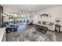 Bright living room with open lanai access, neutral colors, and stylish furnishings at 335 Sunset Lake Blvd, Venice, FL 34292