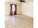 Spacious living room with tile flooring and ceiling fan at 3400 Rain Lily, Englewood, FL 34224