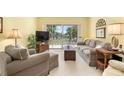 Living room with sliding doors to patio and neutral decor at 458 Cerromar Rd # 483, Venice, FL 34293