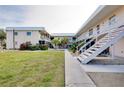 Two-story condo building with a courtyard and walkway at 460 Base E Ave # 122, Venice, FL 34285