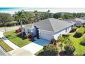 Single-story house with gray roof and lush landscaping at 4940 Thames Ln, Sarasota, FL 34238