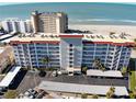 Aerial view of a beachfront condominium building with ocean views and parking at 500 The Esplanade N # 306, Venice, FL 34285
