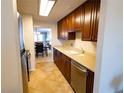 Kitchen with stainless steel appliances and light brown cabinets at 500 The Esplanade N # 306, Venice, FL 34285