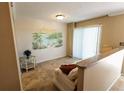 Living room features tiled floors and a tropical mural at 500 The Esplanade N # 306, Venice, FL 34285