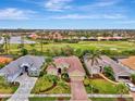 Bird's-eye view of upscale community, showcasing manicured lawns and golf course at 5561 White Ibis Dr, North Port, FL 34287