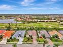 High-angle view of a single Gathering home with a golf course in the background at 5561 White Ibis Dr, North Port, FL 34287