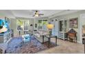 Bright living room featuring a comfy sofa and a large TV at 702 Granada Ave # 7, Venice, FL 34285