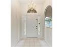 Bright and airy foyer with a chandelier and tiled floor at 7023 Chickasaw Bayou Rd, Bradenton, FL 34203
