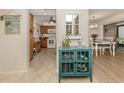 Kitchen with wood cabinets, white appliances, and teal accents at 806 Capri Isles Blvd # 109, Venice, FL 34292