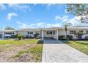 Single story home with paved driveway and mature trees at 833 White Cap Cir # 8, Venice, FL 34285