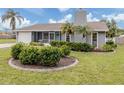 Gray house with white garage door, landscaped lawn, and screened porch at 842 Linden Rd, Venice, FL 34293