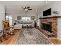 Living room with brick fireplace, hardwood floors, and comfy seating at 842 Linden Rd, Venice, FL 34293