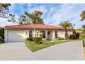 Single-story home with tile roof, attached garage, and a landscaped yard at 858 Senda Plata # 20, Venice, FL 34293