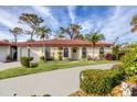 Single-story home with tile roof, landscaped yard, and a curved driveway at 858 Senda Plata # 20, Venice, FL 34293