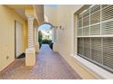Inviting entryway with brick pavers and arched walkway at 901 Triano Cir # 901, Venice, FL 34292