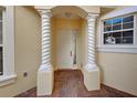 White front door entrance with decorative columns at 901 Triano Cir # 901, Venice, FL 34292