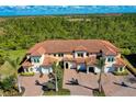 Expansive aerial view of a well maintained two-story townhome community with lush green landscape at 10059 Crooked Creek Dr # 202, Venice, FL 34293