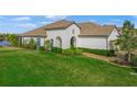 Luxury home exterior with landscaped lawn and lake views at 11204 Mcdermott Ct # 11204, Englewood, FL 34223