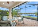 Relaxing screened porch with lake views and outdoor seating at 11204 Mcdermott Ct # 11204, Englewood, FL 34223