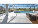 Relaxing pool and spa with screened enclosure, outdoor furniture, and beautiful view at 11571 Gleaming Ter, Venice, FL 34293